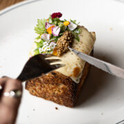 Person about to dig into a small gourmet dish