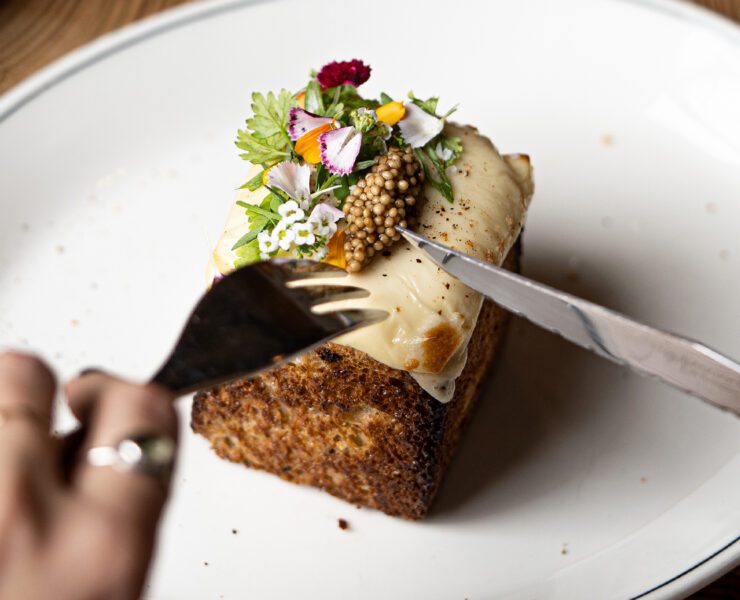 Person about to dig into a small gourmet dish