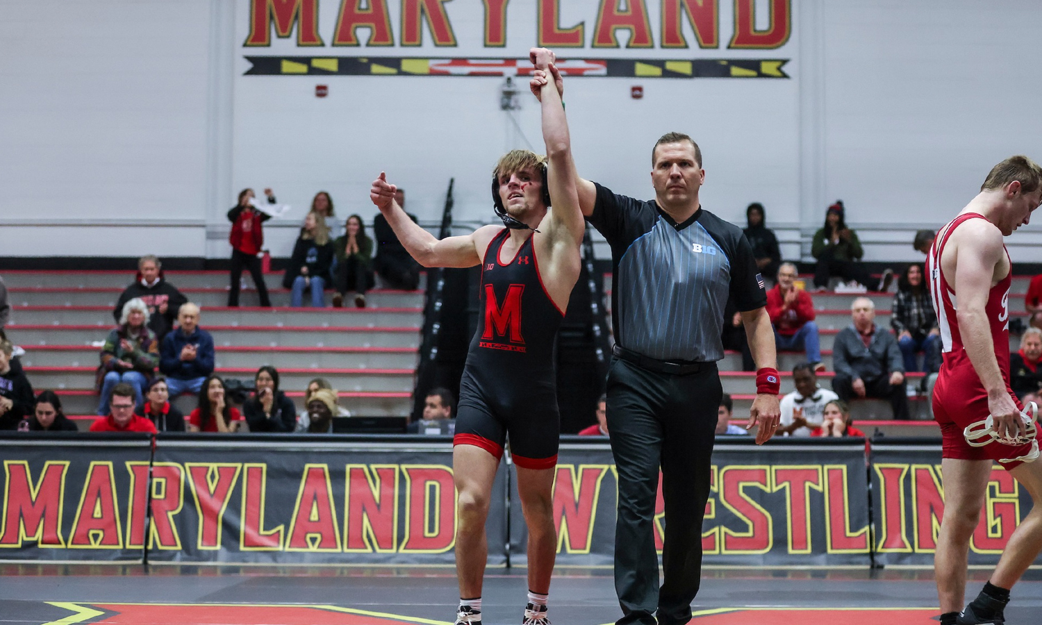Maryland wrestler celebrates a victory during a match