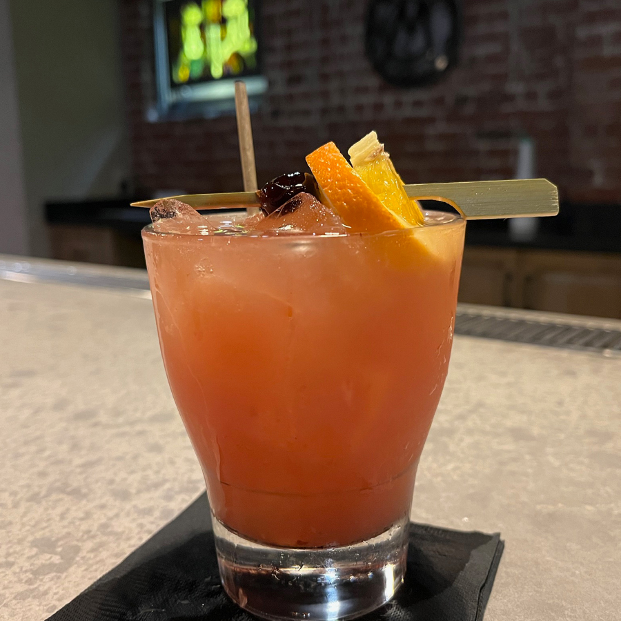 Red/orangeish cocktail on a bar