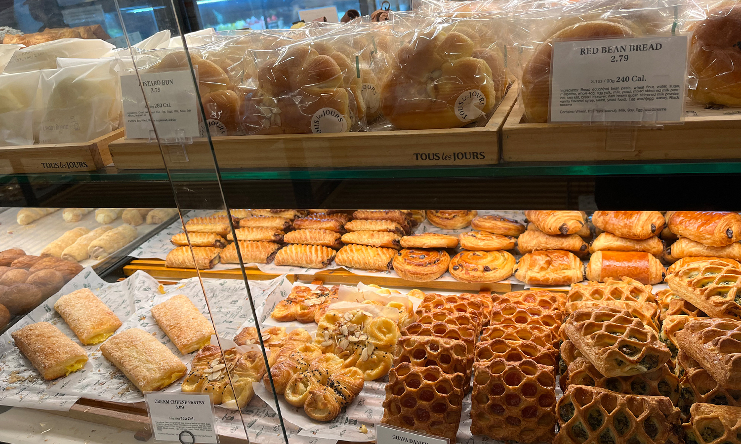Spread of baked good below a counter at a bakery