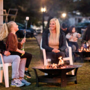 Family making smores by a fire