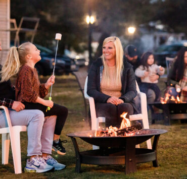 Family making smores by a fire