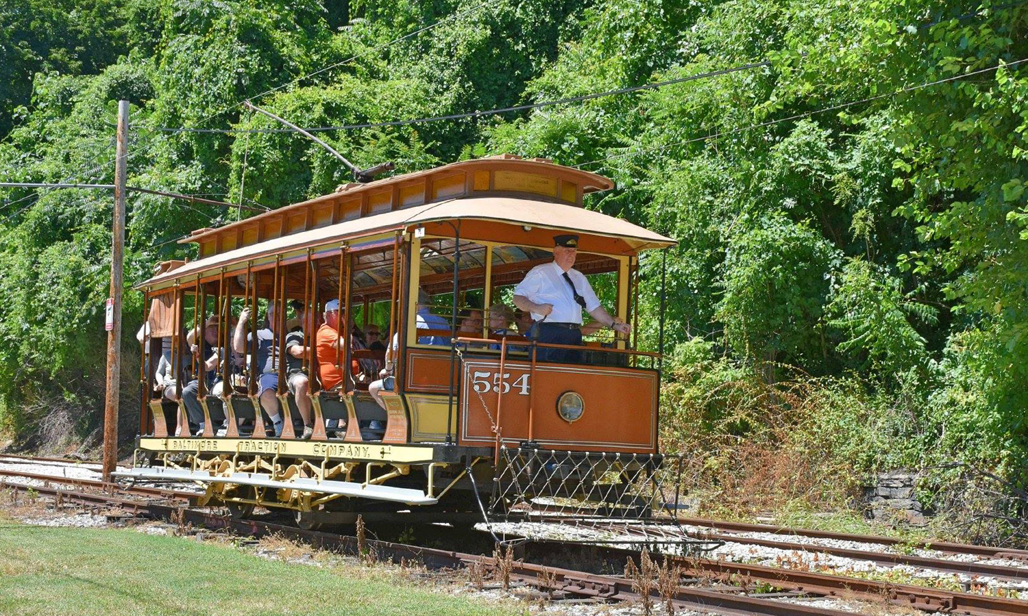 People riding and old street car