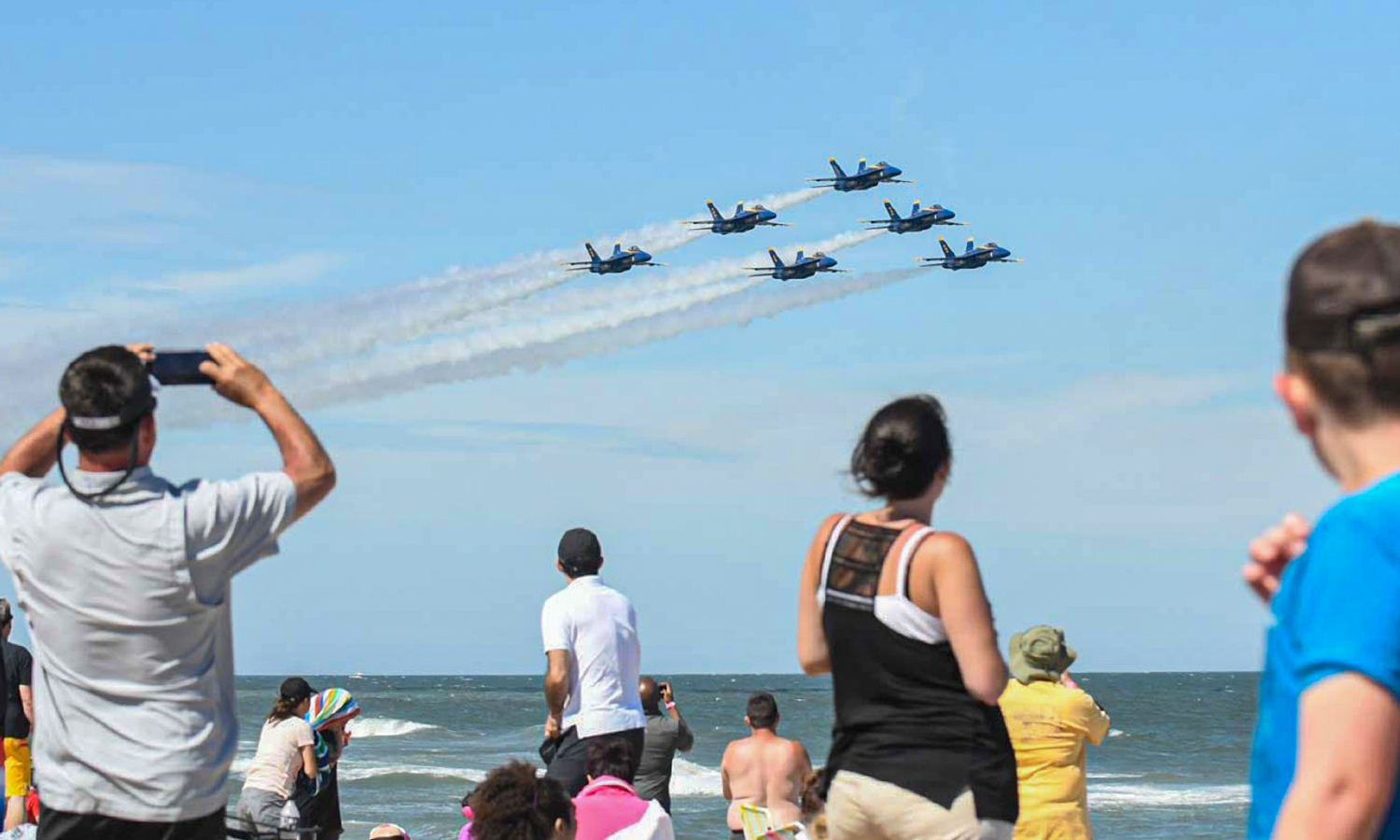 People on beach watching Blue Angels fly by