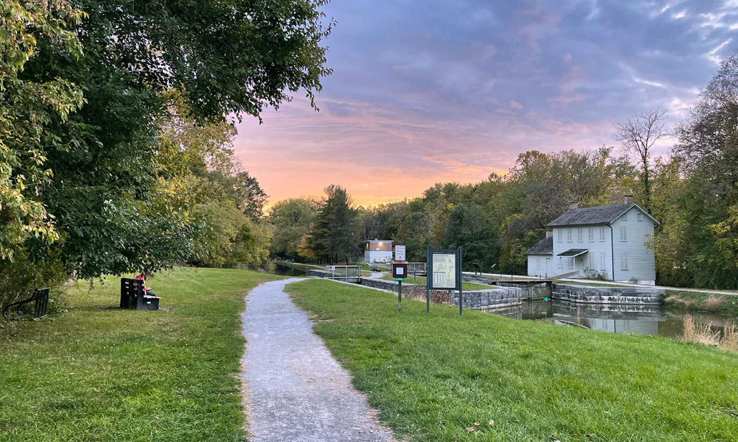 Trail near canal lockhouse during summer twilight